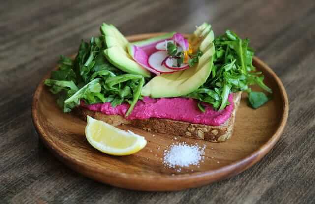 beetroot humous on toast served with avocado 