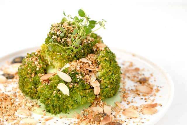 broccoli in white cheese sauce and almonds