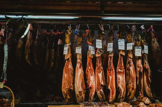 Iberian legs of ham in window shop