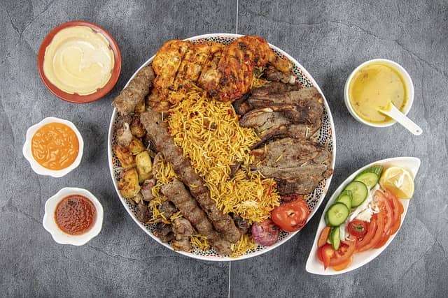 lamb and chicken biryani with side salad and dips