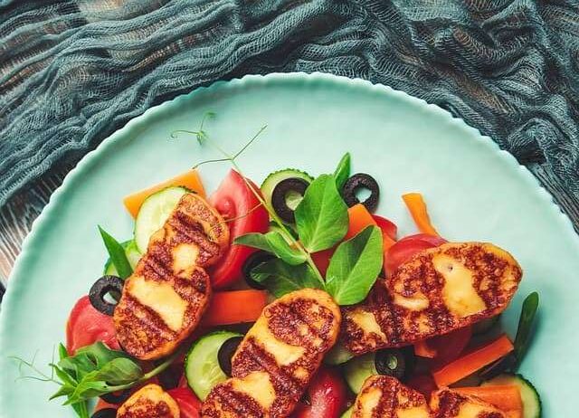 grilled halloumi served with tomato, cucumber, peppers and olives salad
