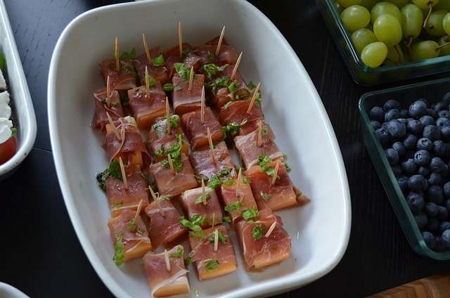 melon bites wrapped in Parma ham on skewers