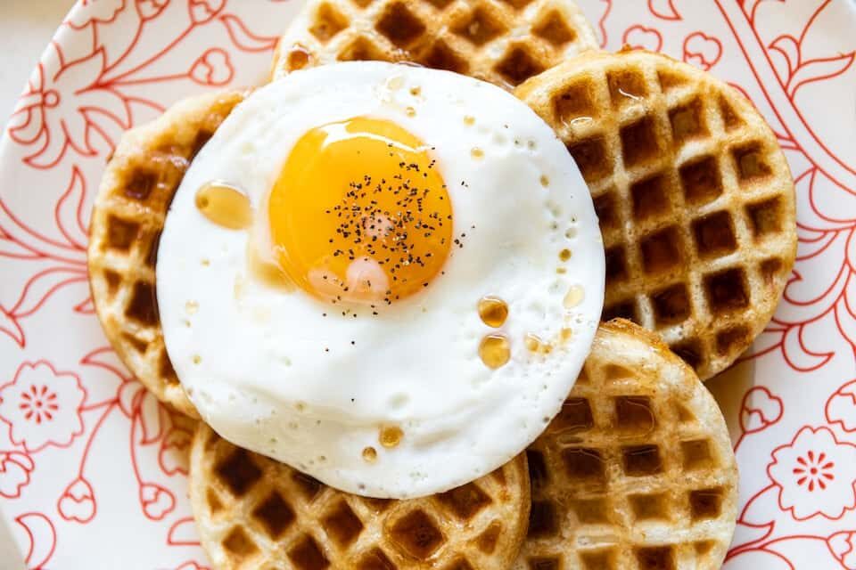 Maple syrup, waffles and egg breakfast dish