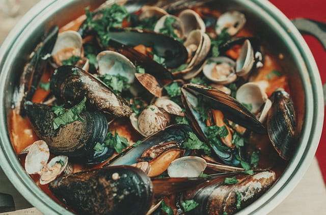 Mussels and clams in tomato sauce with parsley