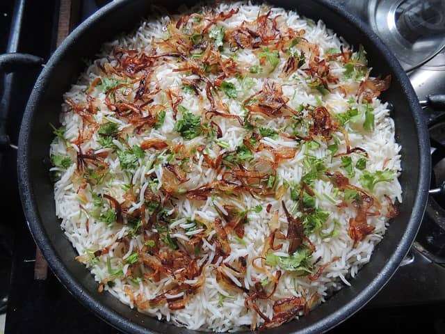 Crispy onion and herbs garnish Biryani dish