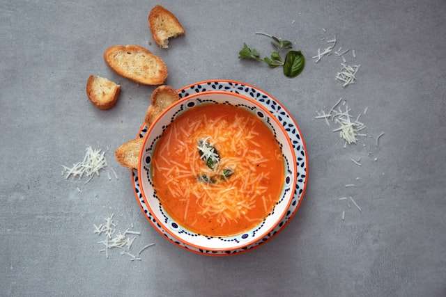 Grated parmesan cheese  in tomato soup