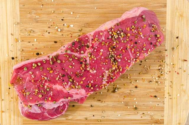 Seasoned sirloin steak with black peppers, salt and spices