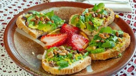 Avocado and pine nuts on toast breakfast dish