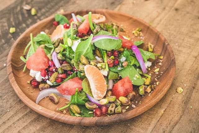 Pistachios, greens and fruits salad
