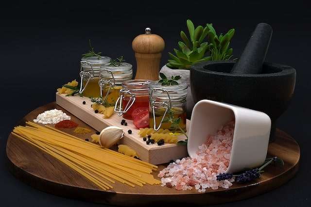 Himalaya pink salt and different spices and ingredients for pasta dish
