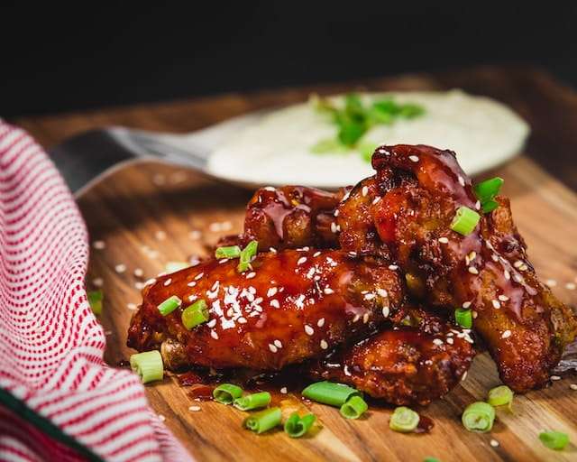 Sesame seeds sprinkled on sweet chili chicken wings