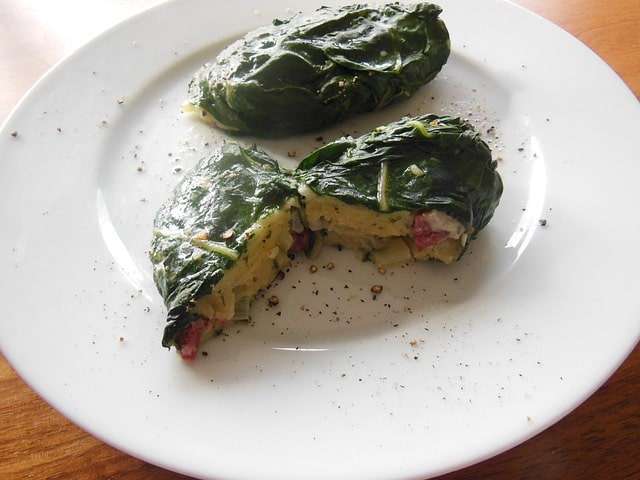 meat and vegetables cooked in swiss chard roll