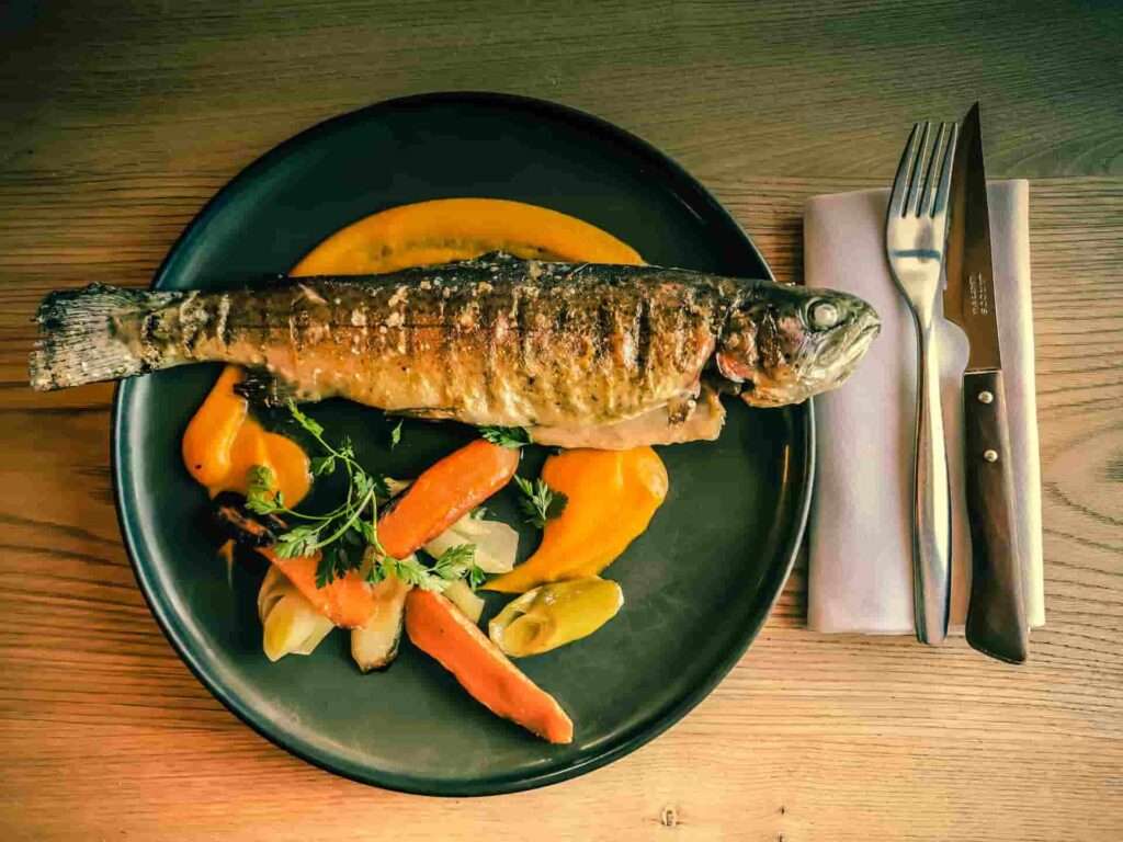 Trout with carrot pure and vegetables dish